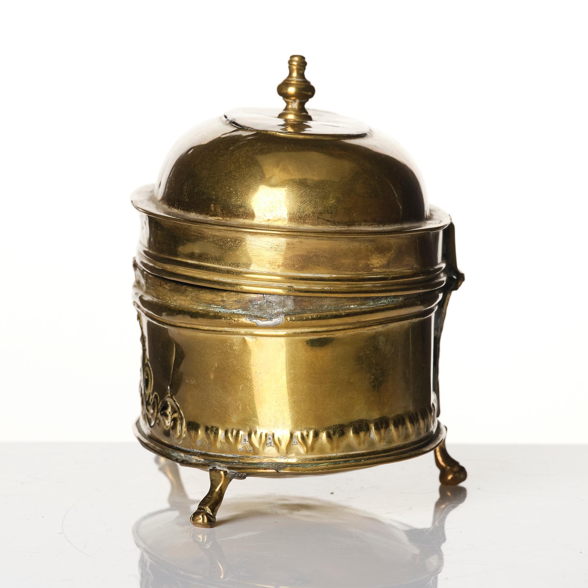 A baroque repousse brass pyxis, 18th century.