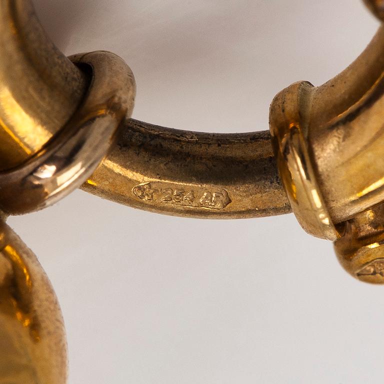 Rannekoru, 18K kultaa ja granaatteja.