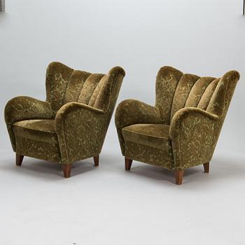 A pair of mid-20th-century armchairs.