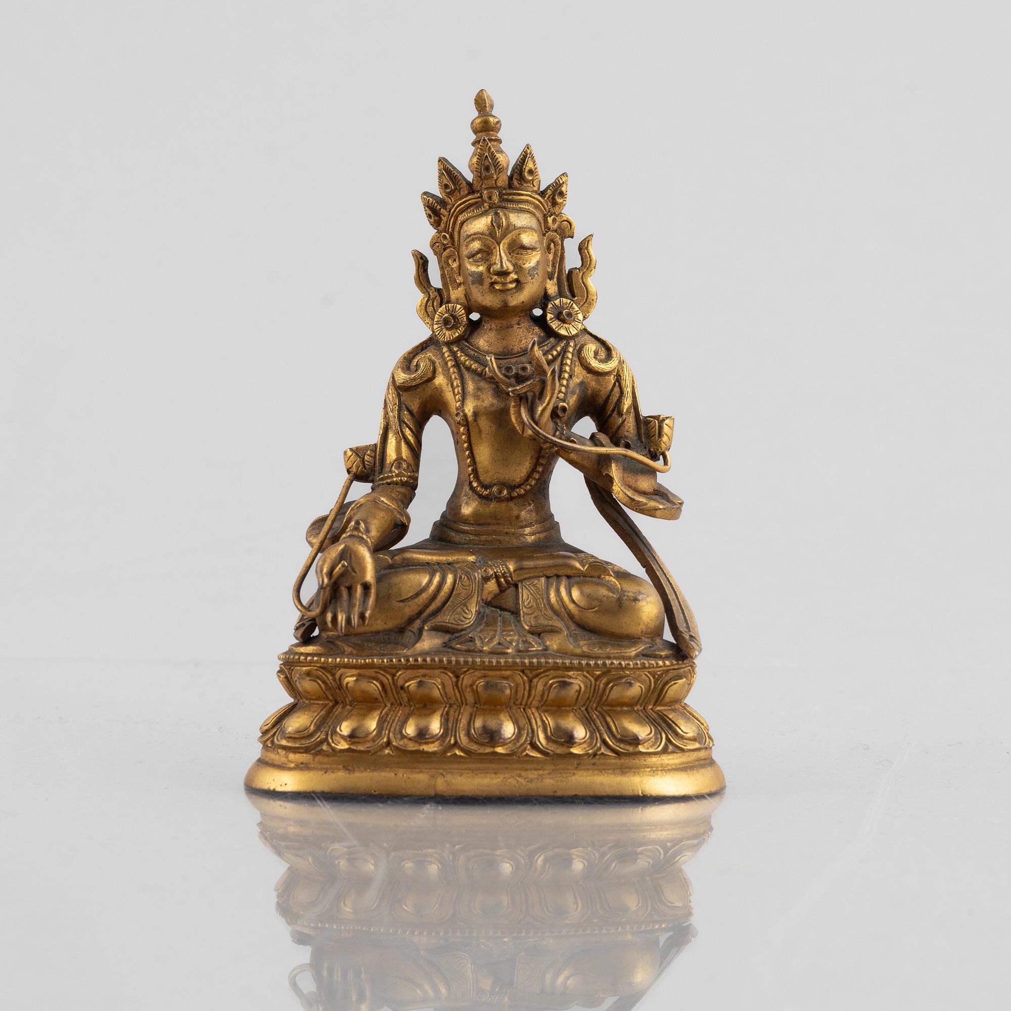 A gilt copper figure of a Buddha, 20th century.