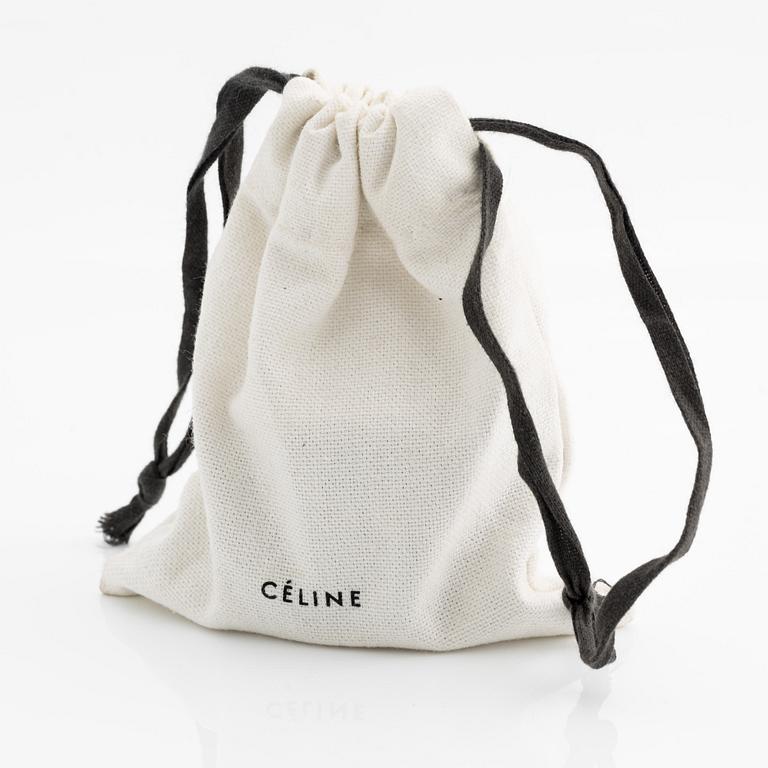 Céline, armring, guldfärgad metall och skinn.