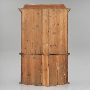 A Swedish polychrome painted folk art corner cabinet, dated 1818.