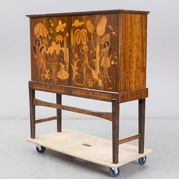 a 1930's Swedish Modern 'Tahiti' intarsia cabinet from Reiners Mjölby, Sweden.