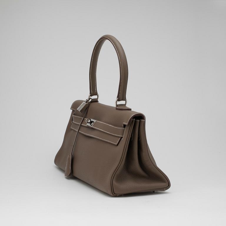 HERMÈS, a Clemence bullcalf "JPG Shoulder Kelly" in the colour "Etoupe".