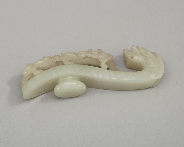 Two pale green nephrite garment hooks, Qing dynasty.