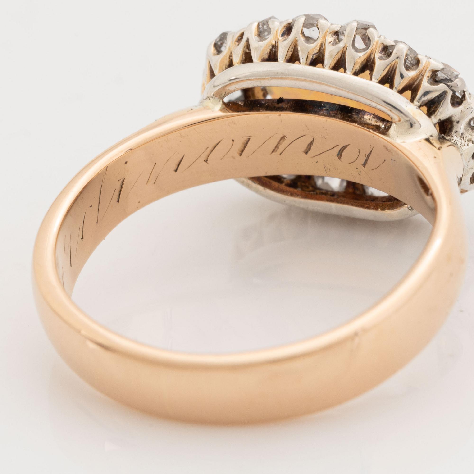 An 18K gold and opal ring set with rose-cut diamonds.