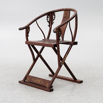 A Chinese hardwood folding chair, 20th century.