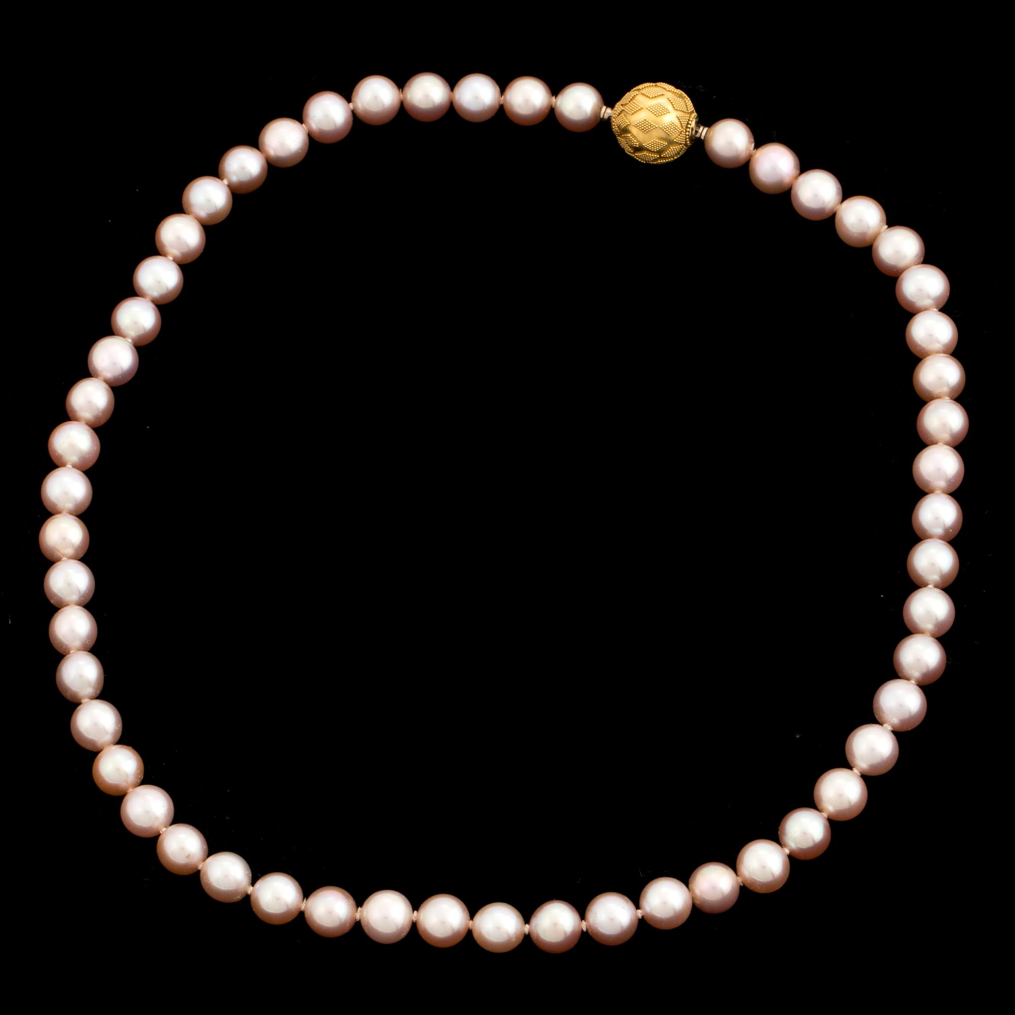 A pearl necklace with an 18K gold clasp by Gaudy according to information given.