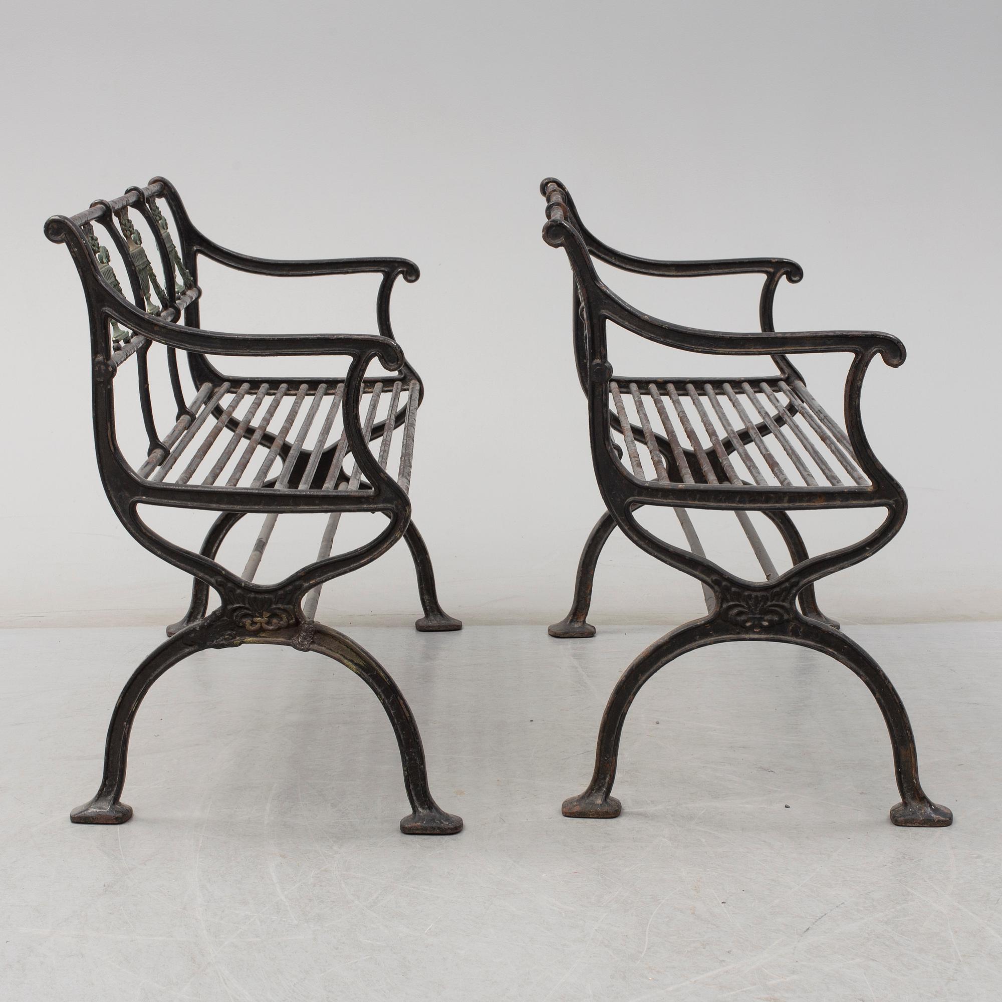GARDEN SOFAS, a pair, cast iron, empire style, late 19th century.