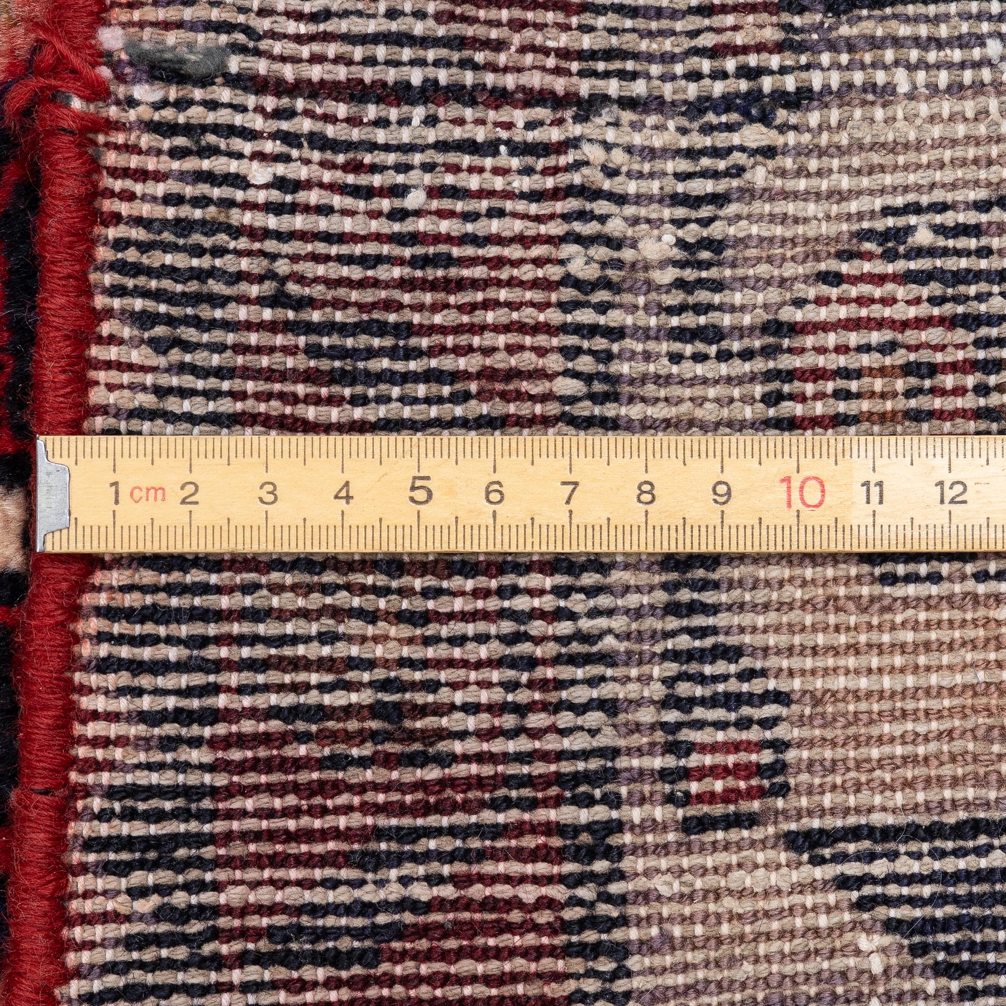 An oriental runner, c. 395 x 100 cm.