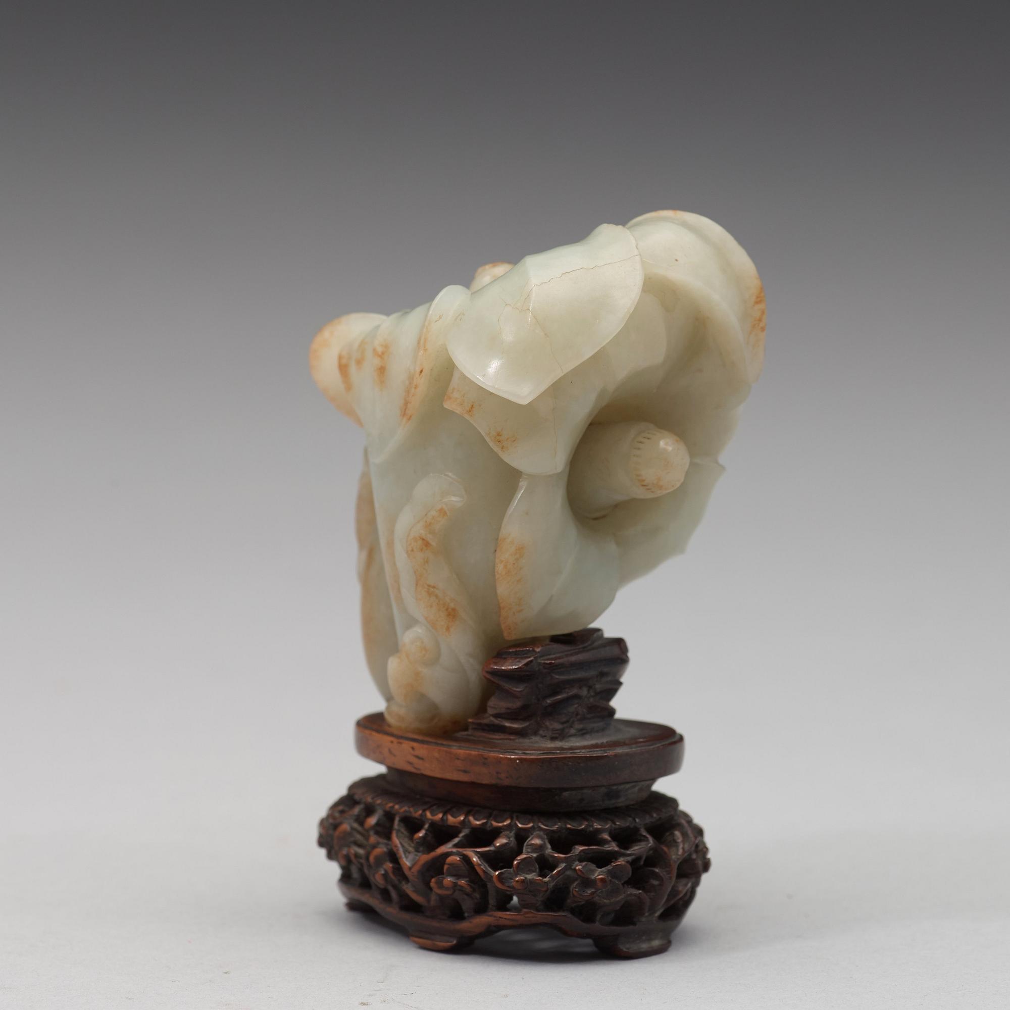 A celadon nephrite floral group, Qing dynasty (1644-1944).
