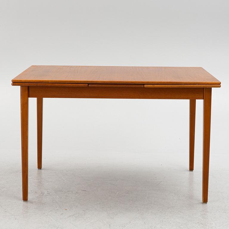 A dining table with four chairs, mid 20th century.