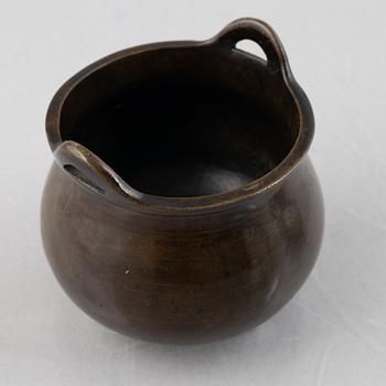 A Chinese bronze tripod censer and two miniature porcelain urns, late Qing dynasty/around 1900.