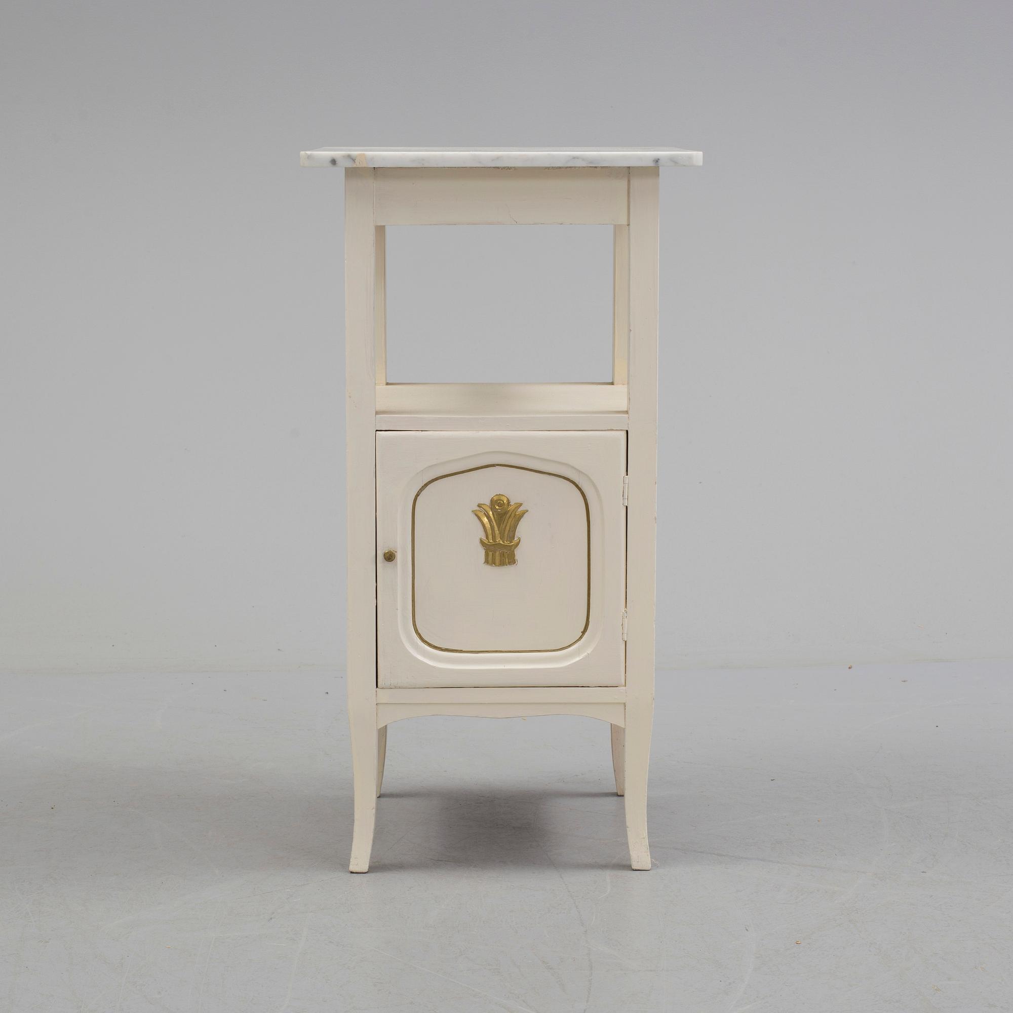 A early bedside table with marble top.