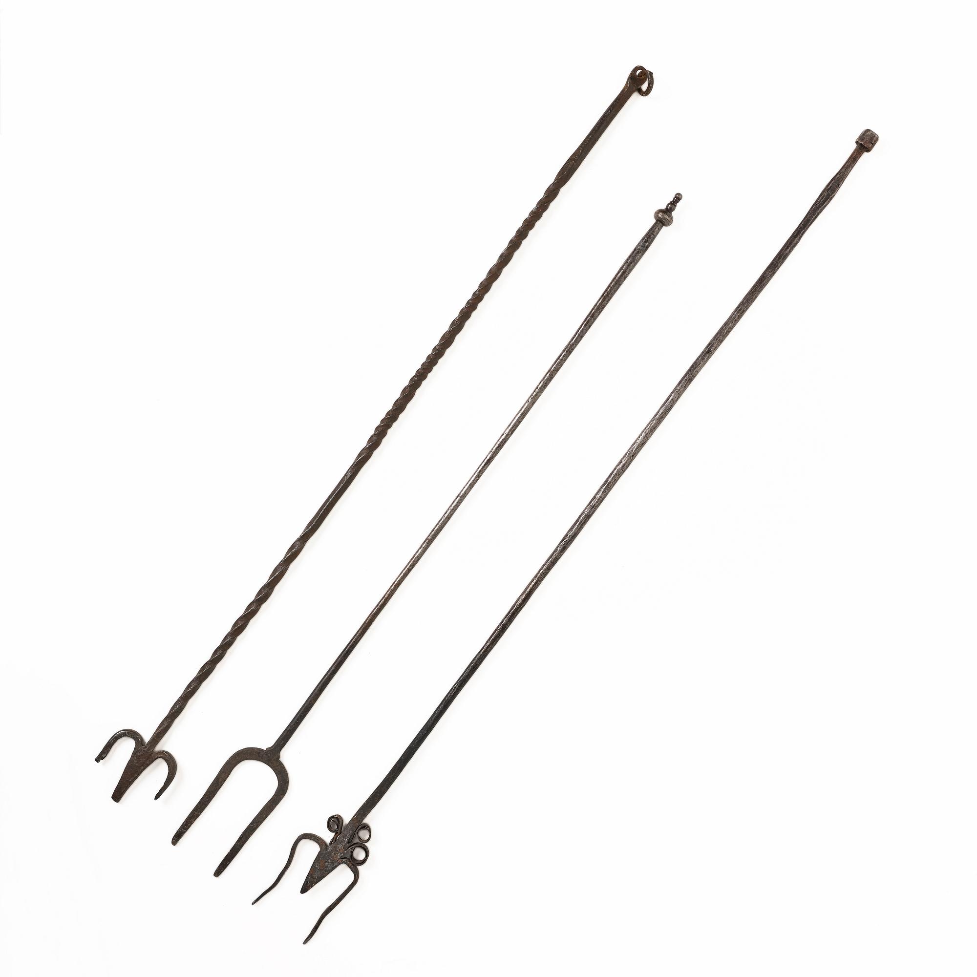 A set of three wrought iron fireplace pokers, 18th / 19th century.
