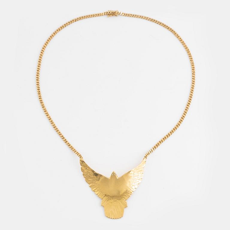 Gold and brilliant cut diamond bird necklace.