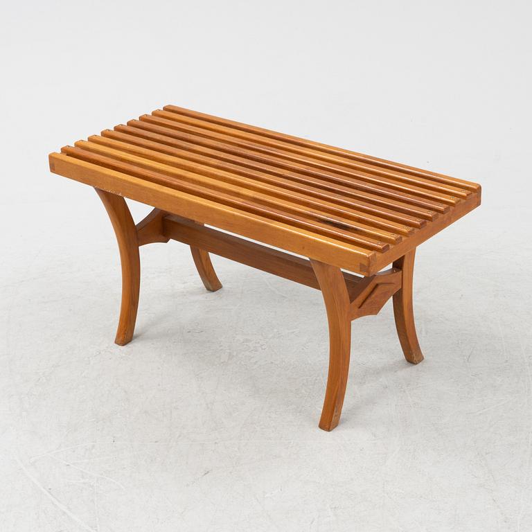 A stained-wood bench, later part of the 20th Century.