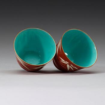 A pair of coral-red ground "Bamboo" cups, Qing dynasty, 19th Century.