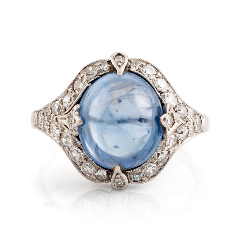 An 18K gold ring set with a cabochon-cut sapphire and eight-cut diamonds.