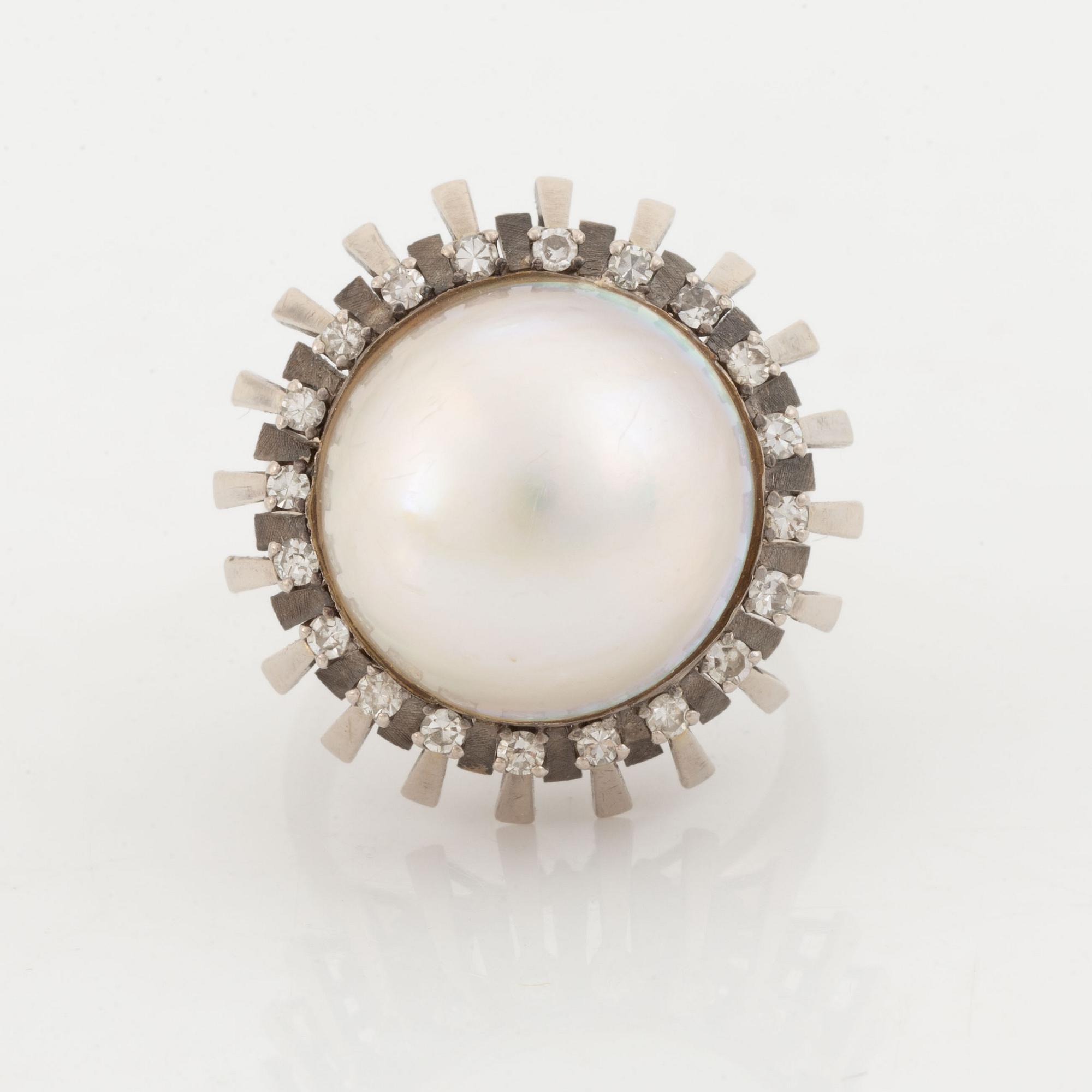A pearl and diamond ring.