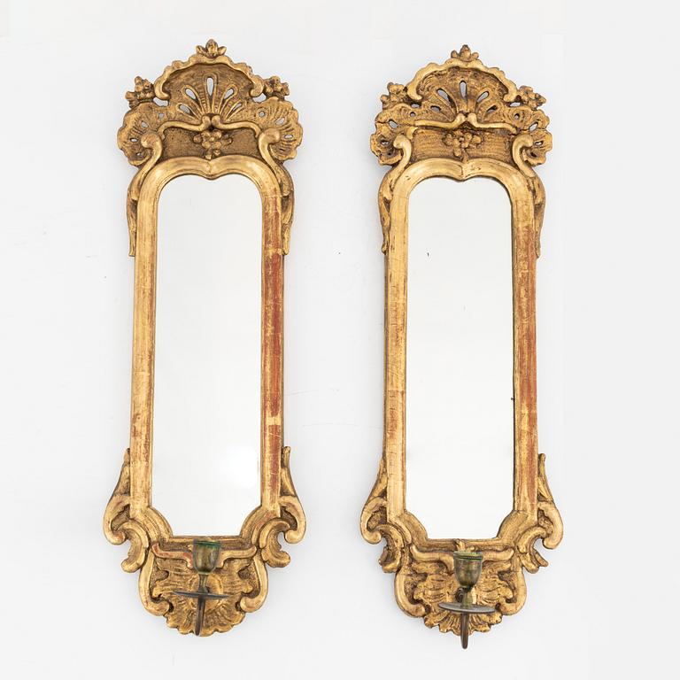 A Rococo giltwood one-light mirrored wall sconce and a Rococo style one-light mirrored wall sconce, 20th Century.