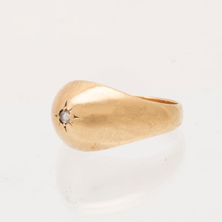A 14K gold ring set with a rose cut diamond.