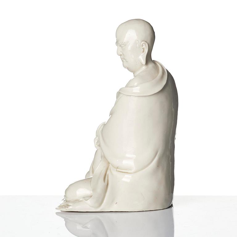 A blanc de Chine seated figure of Bodhidharma, Qing dynasty.