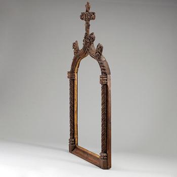 A possibly 16th century carved dark wood picture frame.