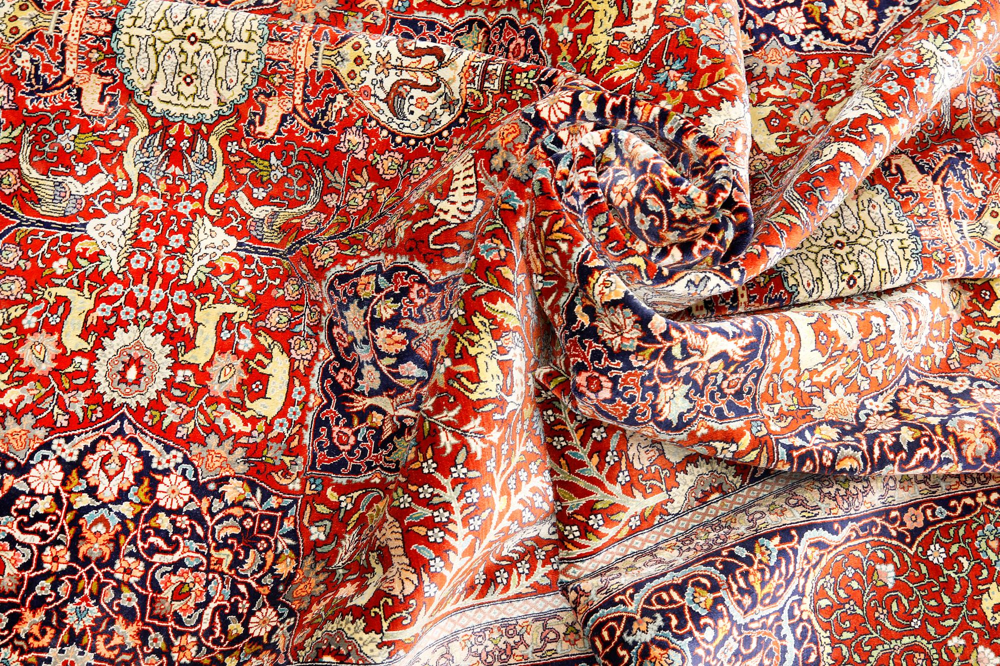 A pictoral orietal silk rug, 246 x 153 cm.