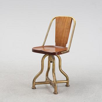 A brass and mahogany ships chair, from the ship Giuseppe Verdi, first half of the 20th Century.
