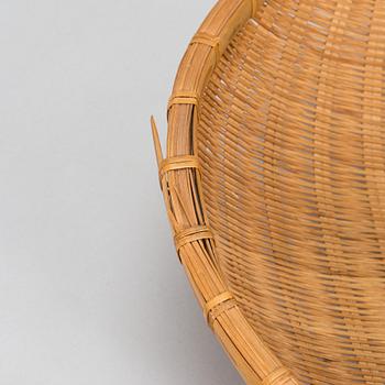 A mid-20th century rattan basket and two rattan trays. Retailer Artek Finland.