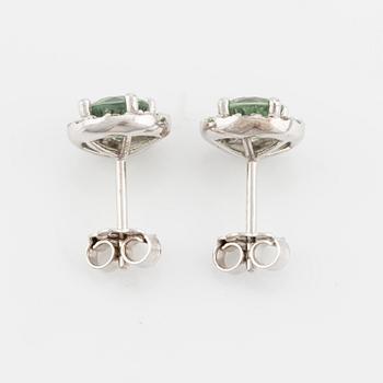 A pair of 18K gold earrings with green faceted sapphires and round brilliant-cut diamonds.