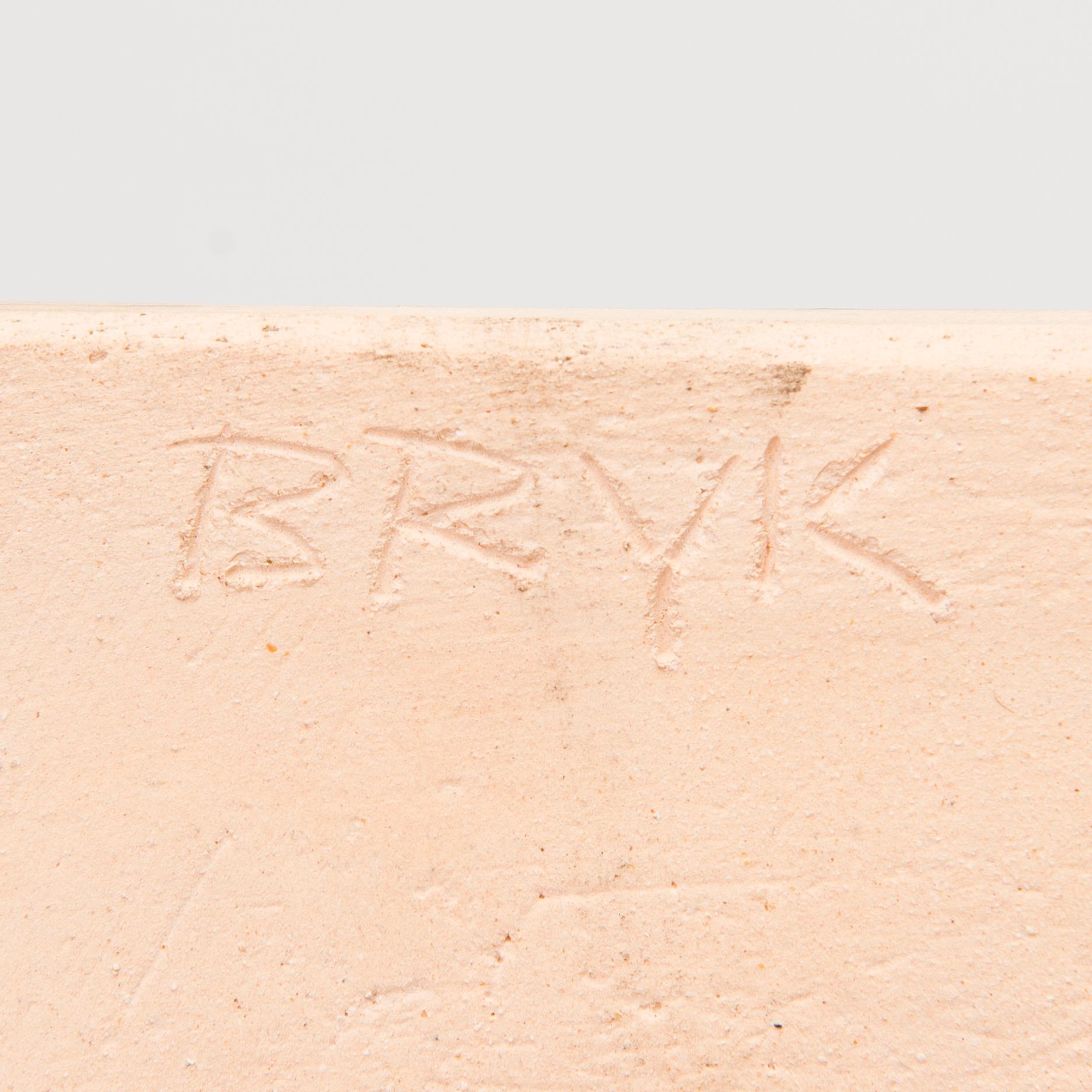 A stoneware relief signed BRYK.