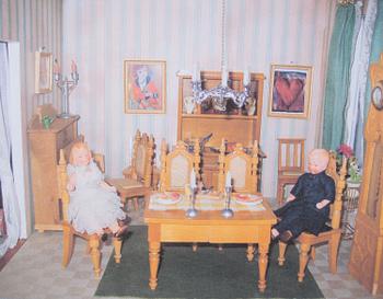 A doll house with interior and dolls ca 1910.