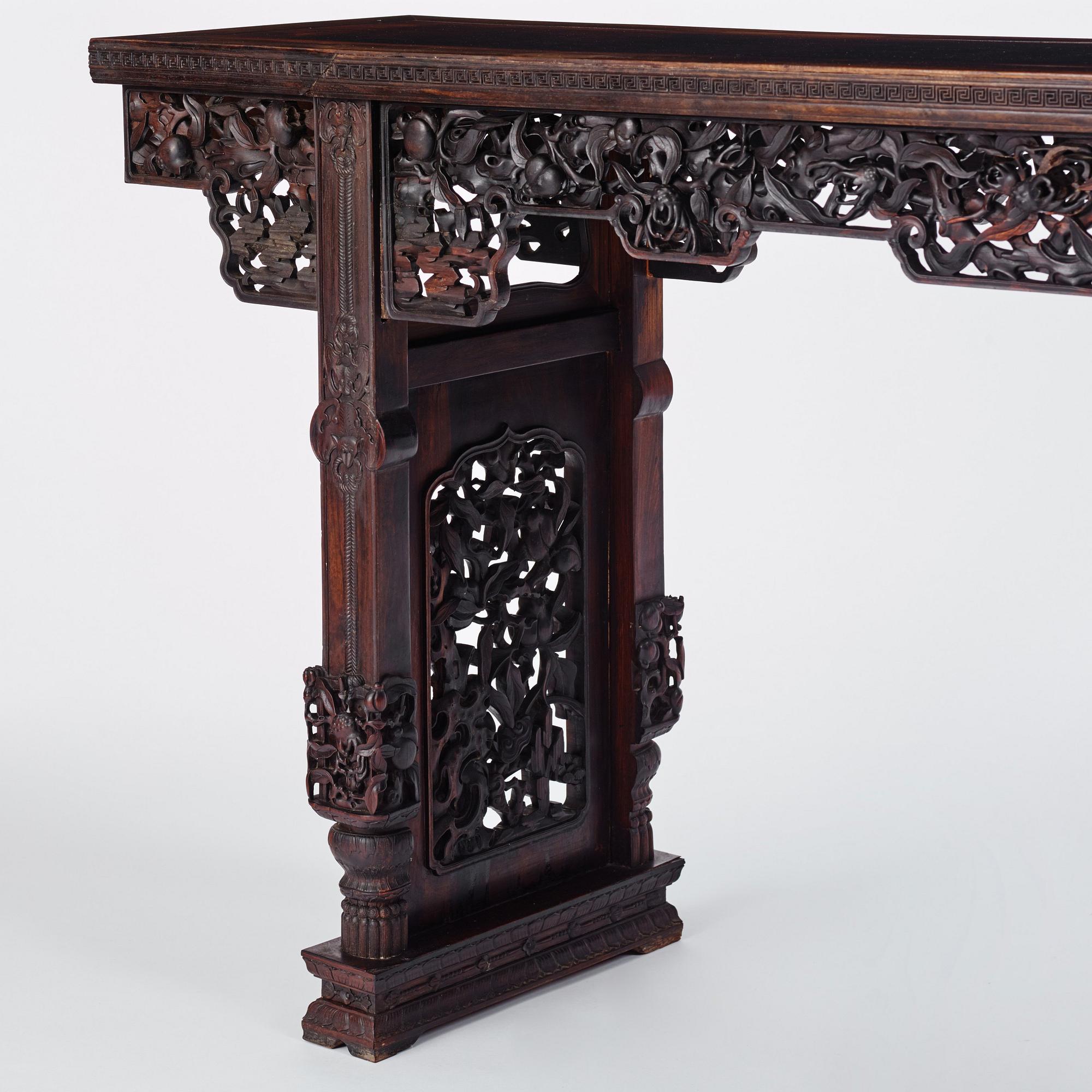 A massive zitan recessed-leg long table 'Jiaotousun Qiotouan', Qing dynasty, 19th century.