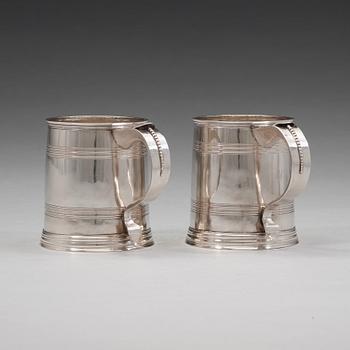 A pair of English early 18th century silver muggs, mark of John Cory, London 1704.