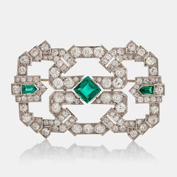 900. A platinum brooch set with old-cut diamonds and faceted green paste.