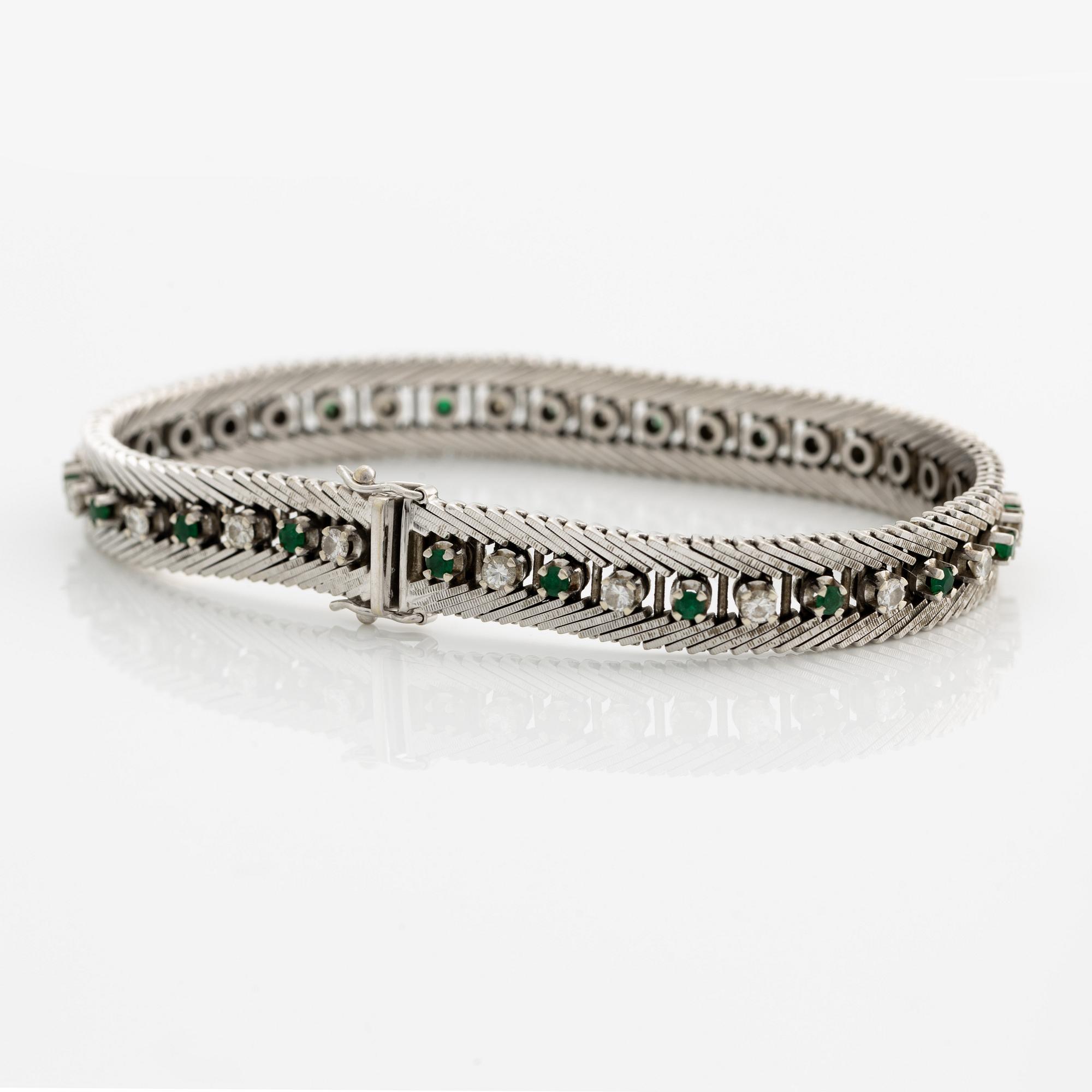 Bracelet 18K gold with round brilliant-cut diamonds and green stones, likely emeralds.