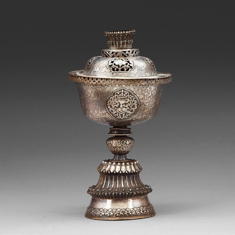 A Tibetan silver butter lamp with cover, 19th Century.