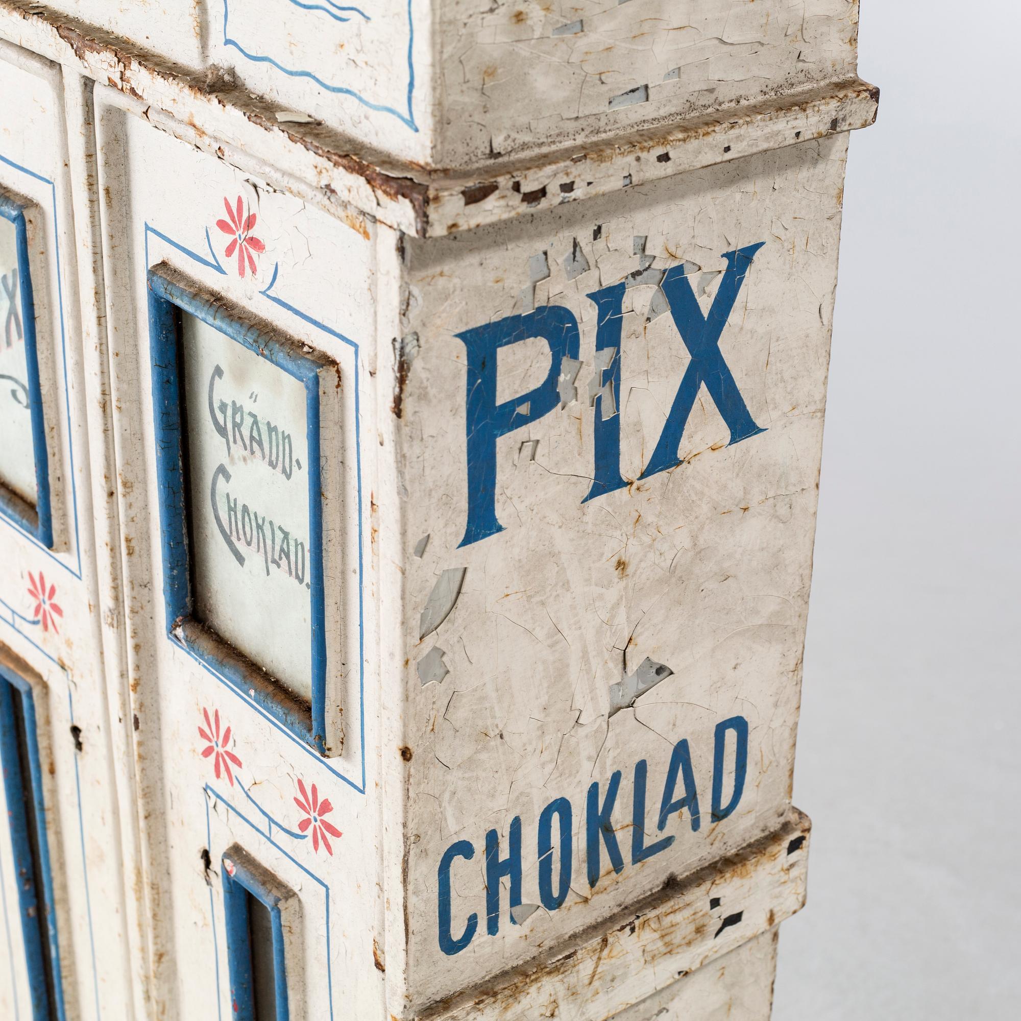 A circa turn of the century candy dispenser.