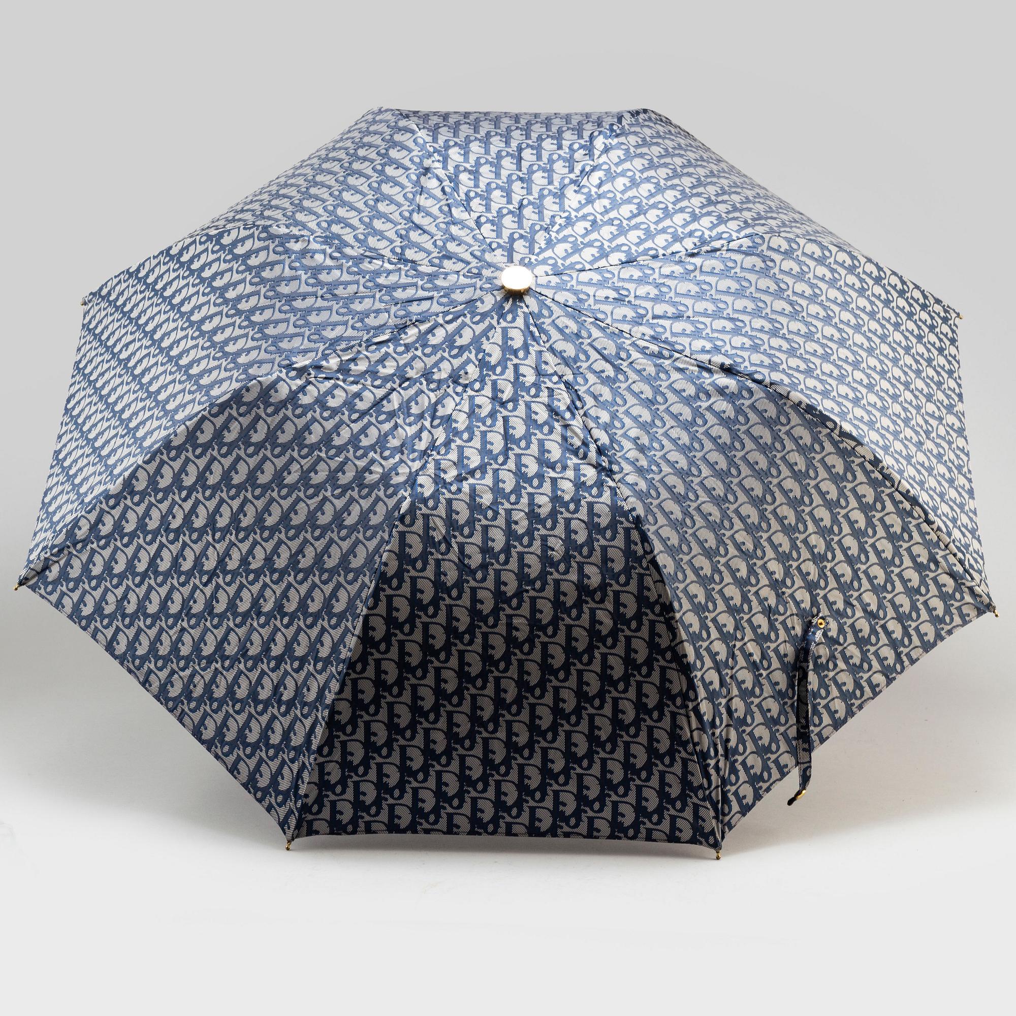CHRISTIAN DIOR, a set of a clutch, a belt and an umbrella.
