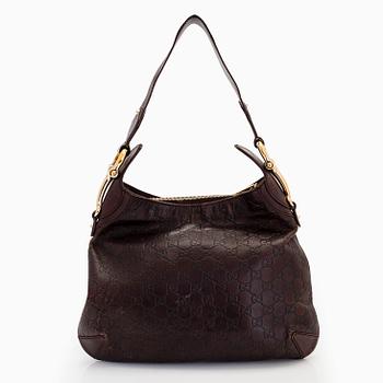 Gucci, a leather shoulder bag.