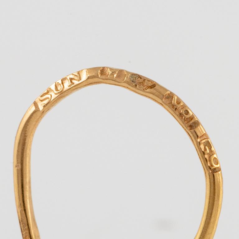 A pair of earrings in 18K gold with purple stones.