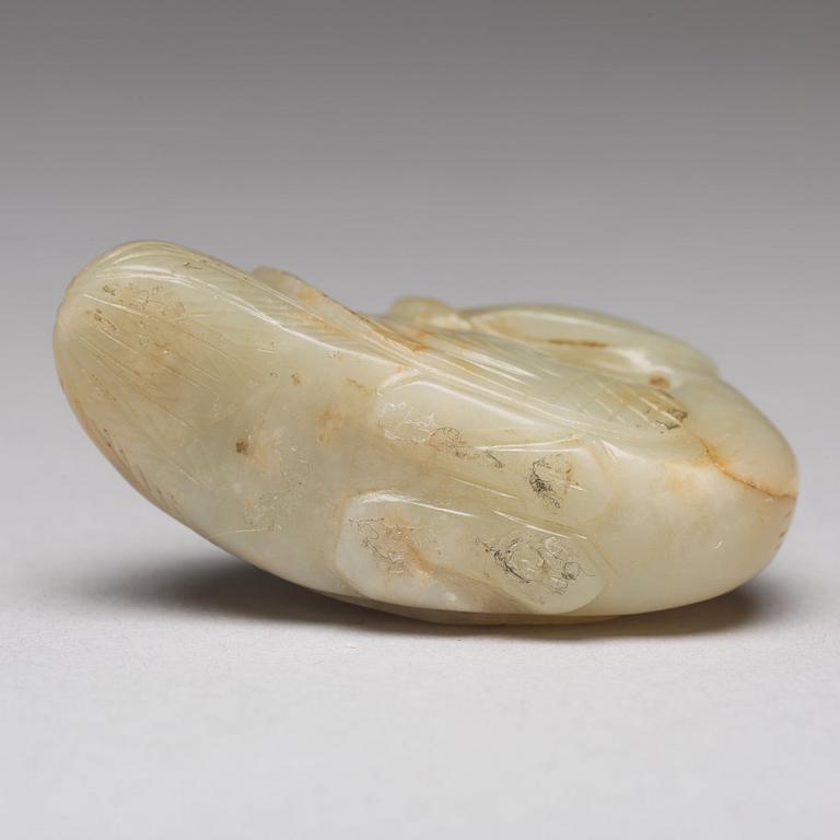 A Chinese nephrite figure of a duck with a lotus bud.