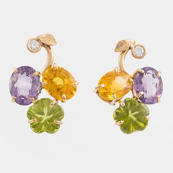 Earrings with yellow sapphires, cut flower-shaped peridot, amethyst, and brilliant-cut diamonds.