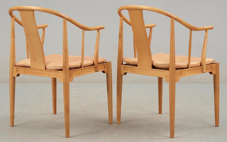 A pair of Hans J Wegner cherrywood and beige leather 'China chairs', Fritz Hansen, Denmark 1988.