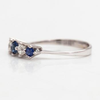 An 18K white gold ring, diamonds totalling approx. 0.20 ct and sapphires.