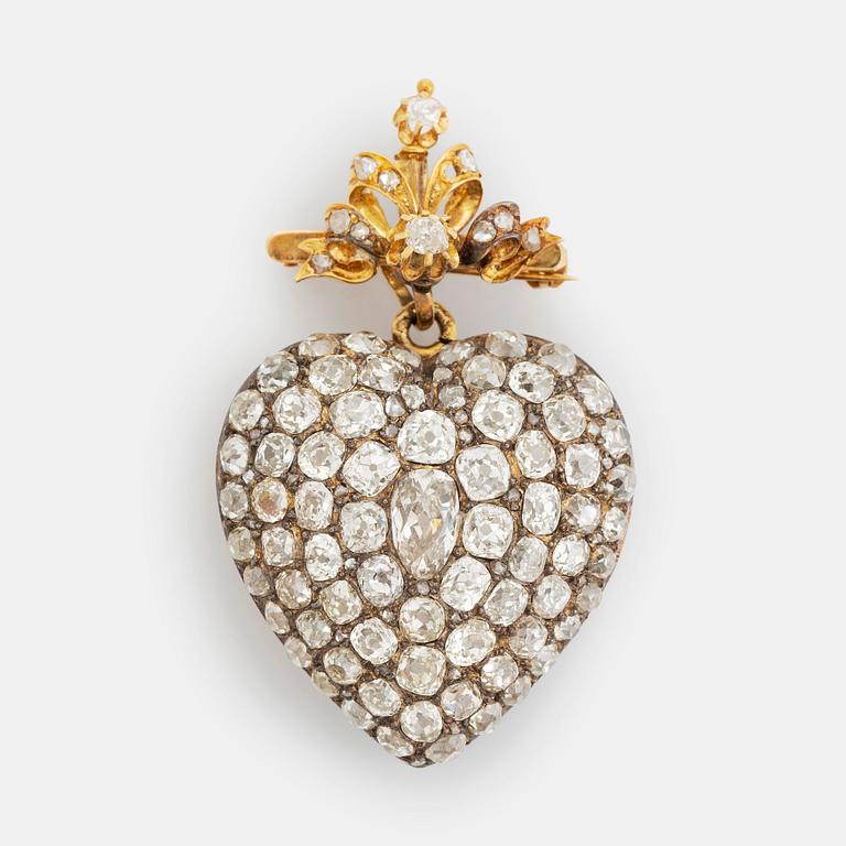 A pendant/locket in 18K gold set with old-cut diamonds, in the form of a heart.