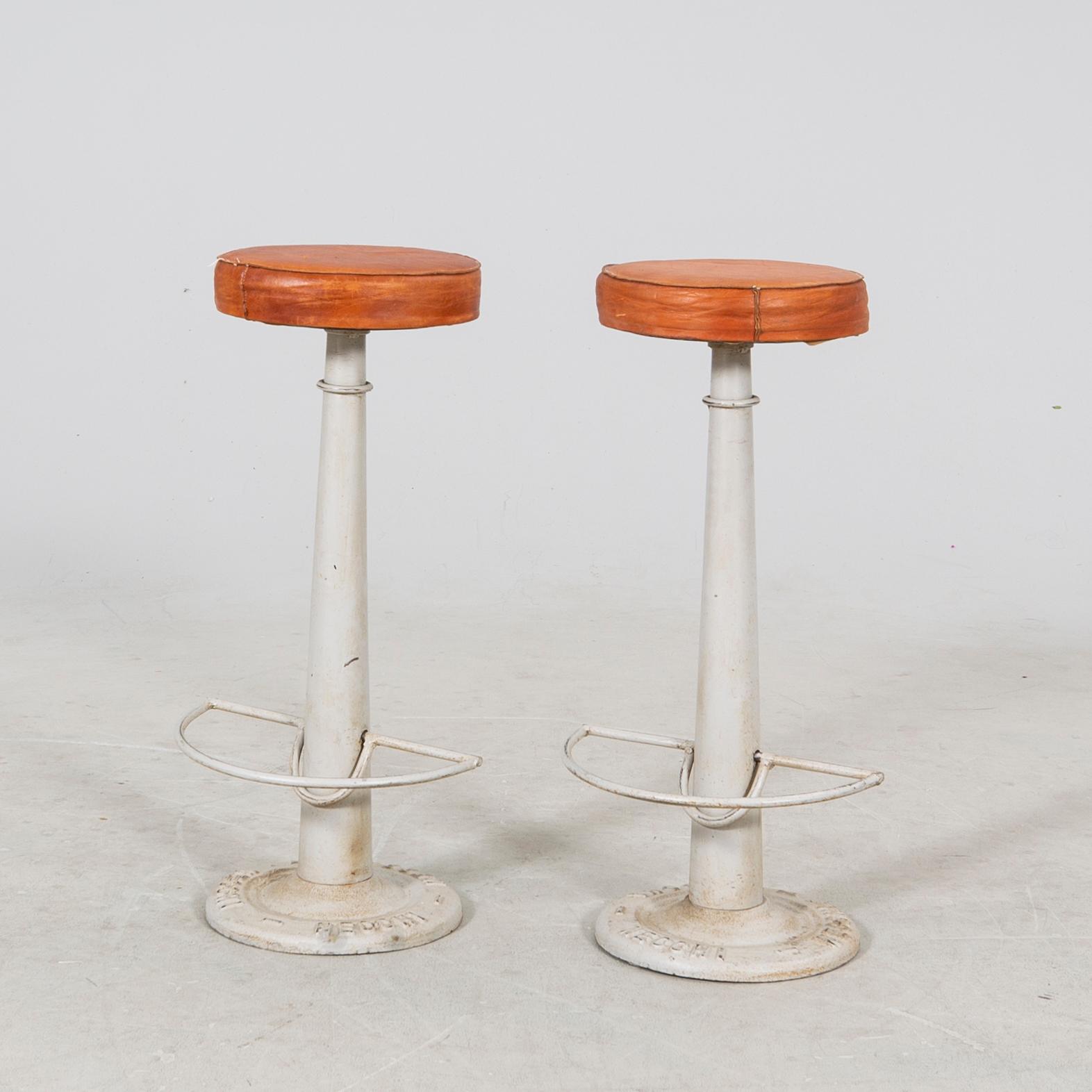 A pair of Necchi leather and metal bar stools later part of the 20th century.
