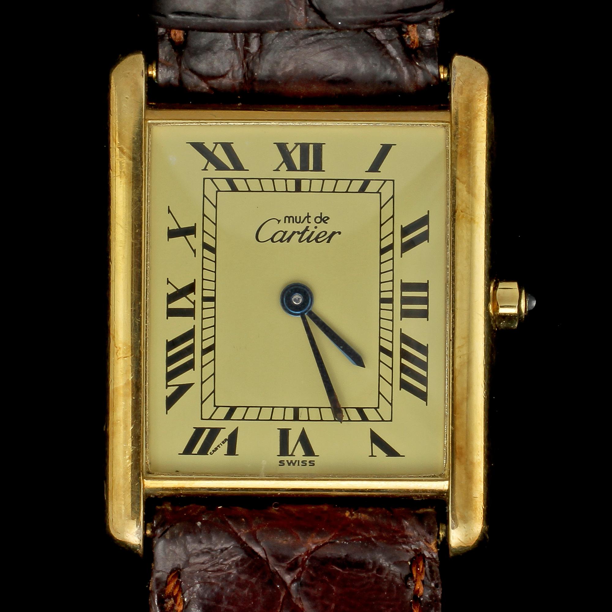 ARMBANDSUR, förgyllt silver, must de Cartier, Tank. Vikt 24 g.